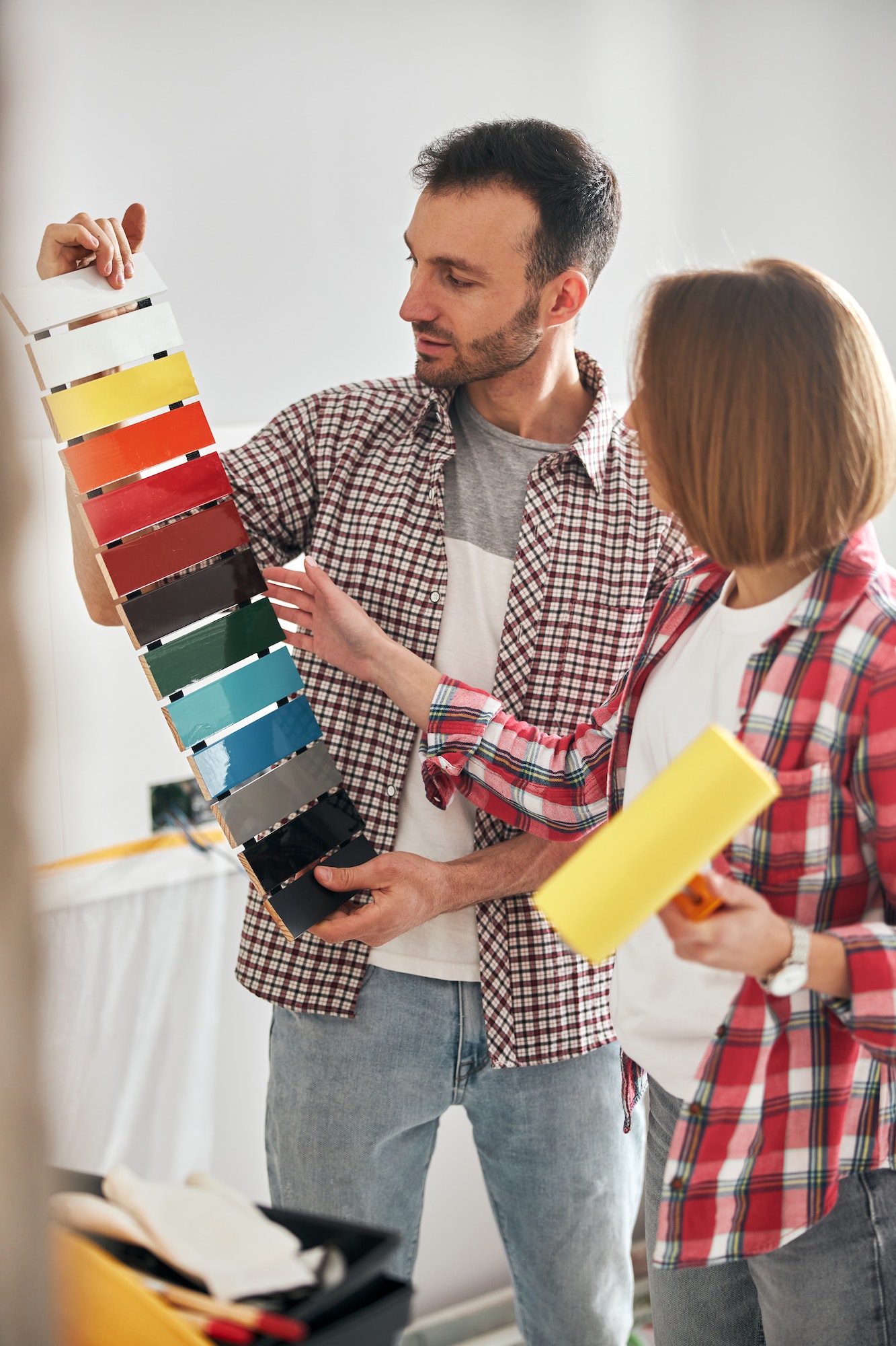 Two workpeople selecting the right interior paint